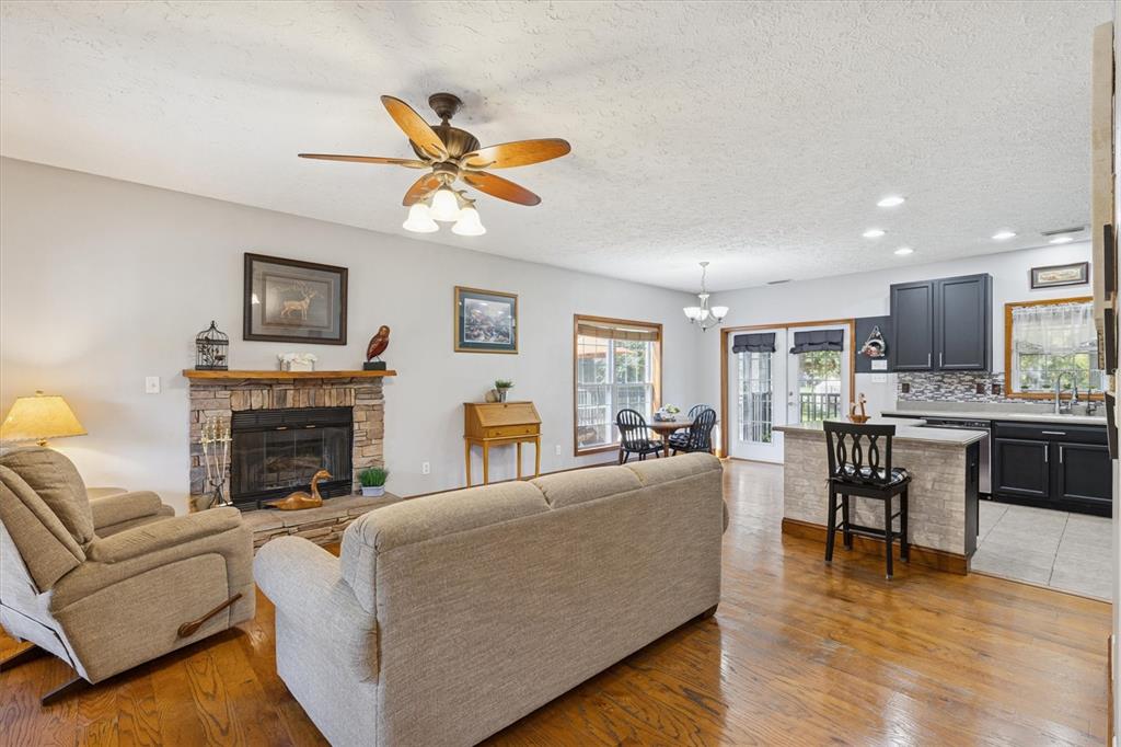 16607 Bearle Road Orlando, FL 32828 - Photo 27 of 57 a living room with furniture a fireplace and kitchen view