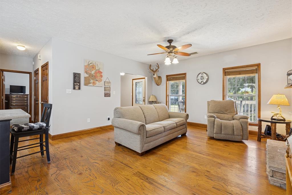16607 Bearle Road Orlando, FL 32828 - Photo 29 of 57 a living room with furniture and a chandelier