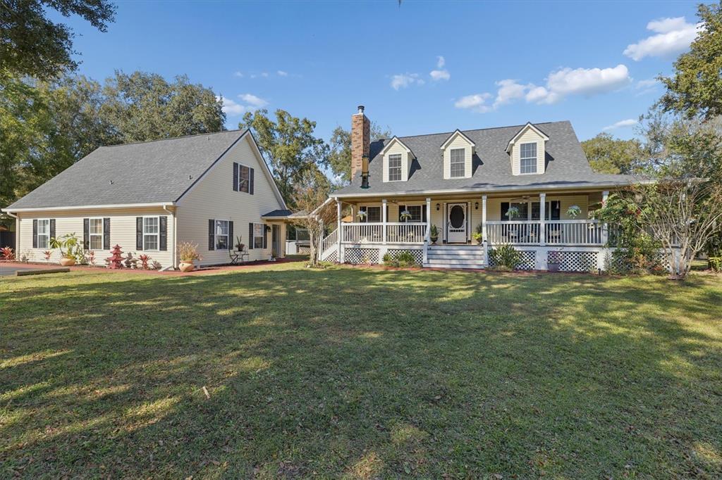 16607 Bearle Road Orlando, FL 32828 - Photo 3 of 57 a front view of a house with a garden