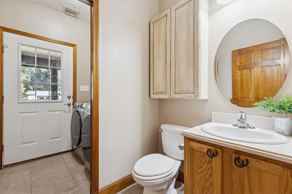 16607 Bearle Road Orlando, FL 32828 - Photo 36 of 57 a bathroom with a sink a toilet and mirror