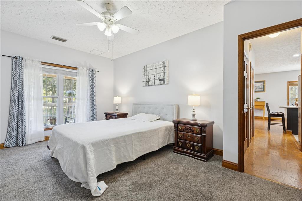 16607 Bearle Road Orlando, FL 32828 - Photo 39 of 57 a bedroom with a bed and a chandelier