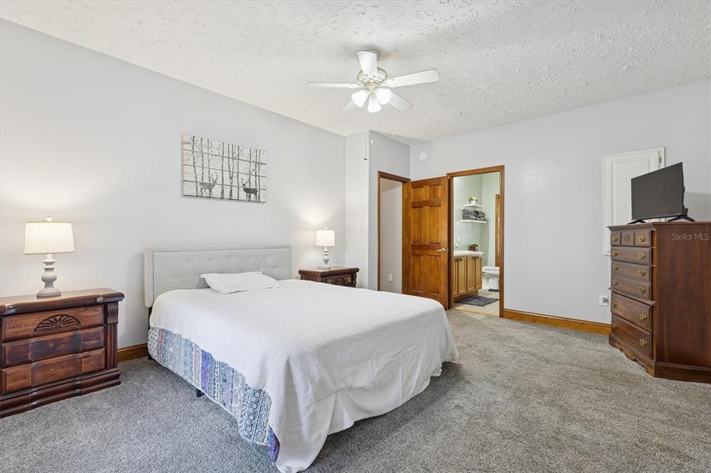 16607 Bearle Road Orlando, FL 32828 - Photo 40 of 57 a bedroom with a bed and a chandelier