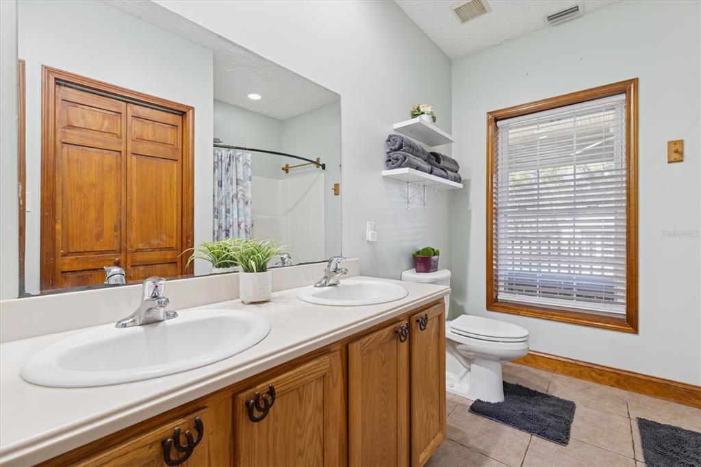 16607 Bearle Road Orlando, FL 32828 - Photo 41 of 57 a bathroom with a sink and a mirror