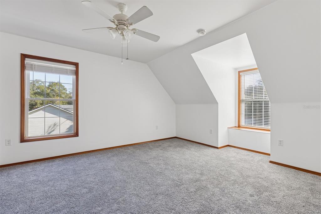 16607 Bearle Road Orlando, FL 32828 - Photo 49 of 57 an empty room with windows and ceiling fan