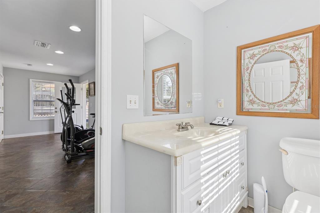 16607 Bearle Road Orlando, FL 32828 - Photo 52 of 57 a bathroom with a toilet a sink and a mirror