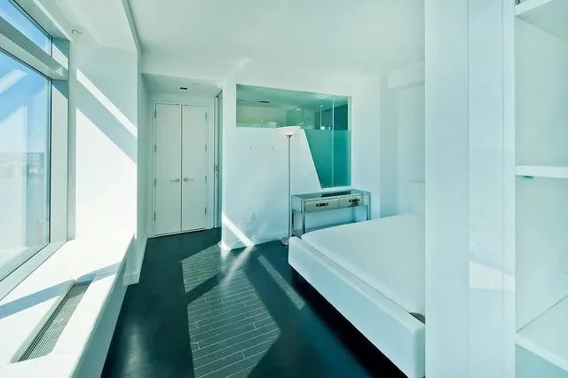 a kitchen with a sink a stove and white cabinets