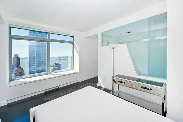 a view of hallway with wooden floor and stairs