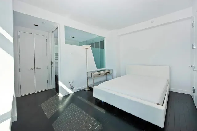 a living room with a bed and a window