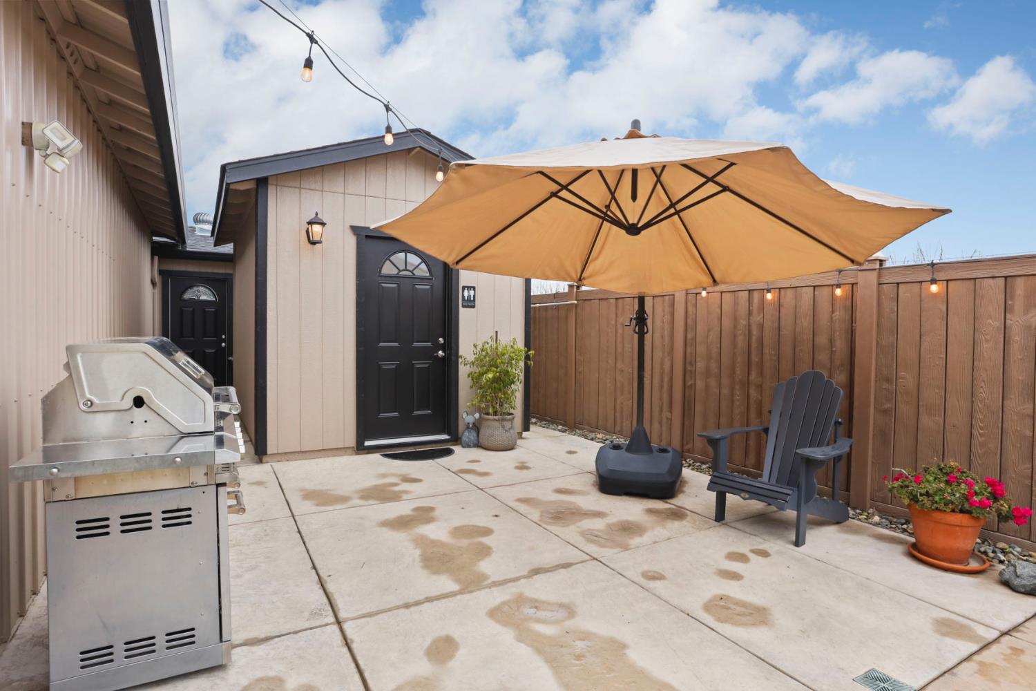 23346 Frederick Road Ripon, CA 95366 - Photo 78 of 96 a backyard of a house with barbeque oven table and chairs
