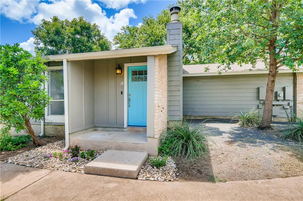 6713 West Gate Boulevard, Unit A Austin, TX 78745 - Photo 1 of 21 a front view of a house with a yard and garage