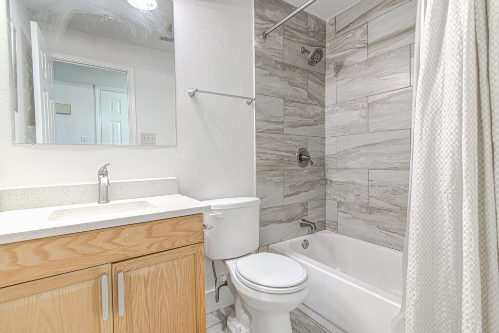 6713 West Gate Boulevard, Unit A Austin, TX 78745 - Photo 14 of 21 a bathroom with a sink toilet and shower