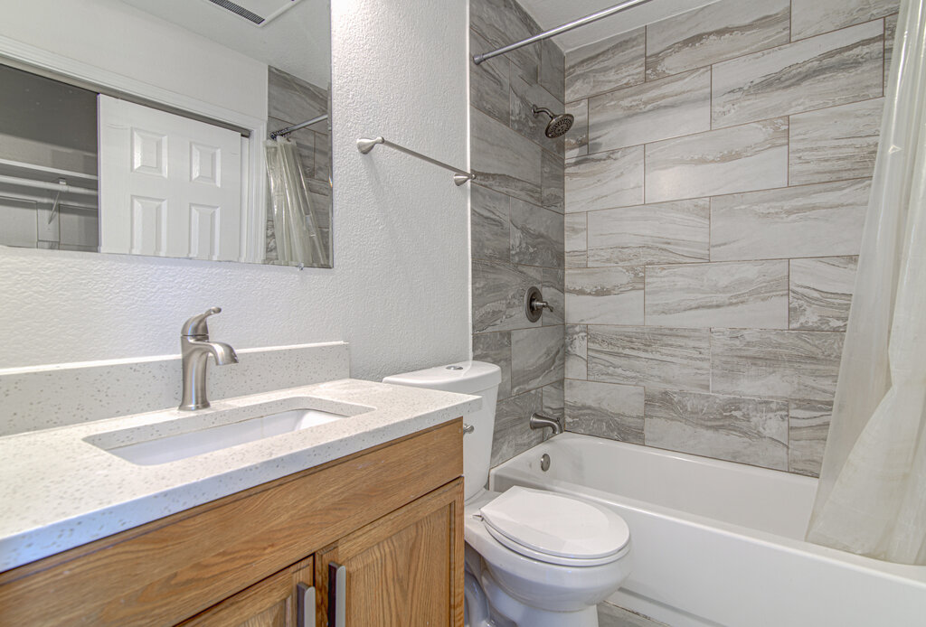 6713 West Gate Boulevard, Unit A Austin, TX 78745 - Photo 17 of 21 a bathroom with a sink toilet vanity and shower