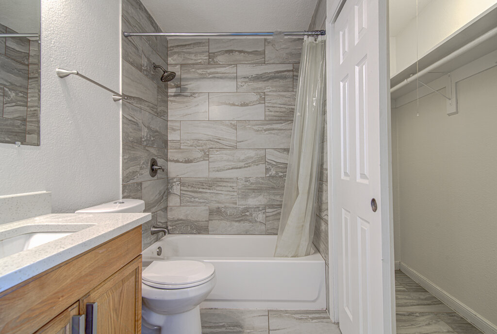 6713 West Gate Boulevard, Unit A Austin, TX 78745 - Photo 18 of 21 a bathroom with a sink toilet and shower