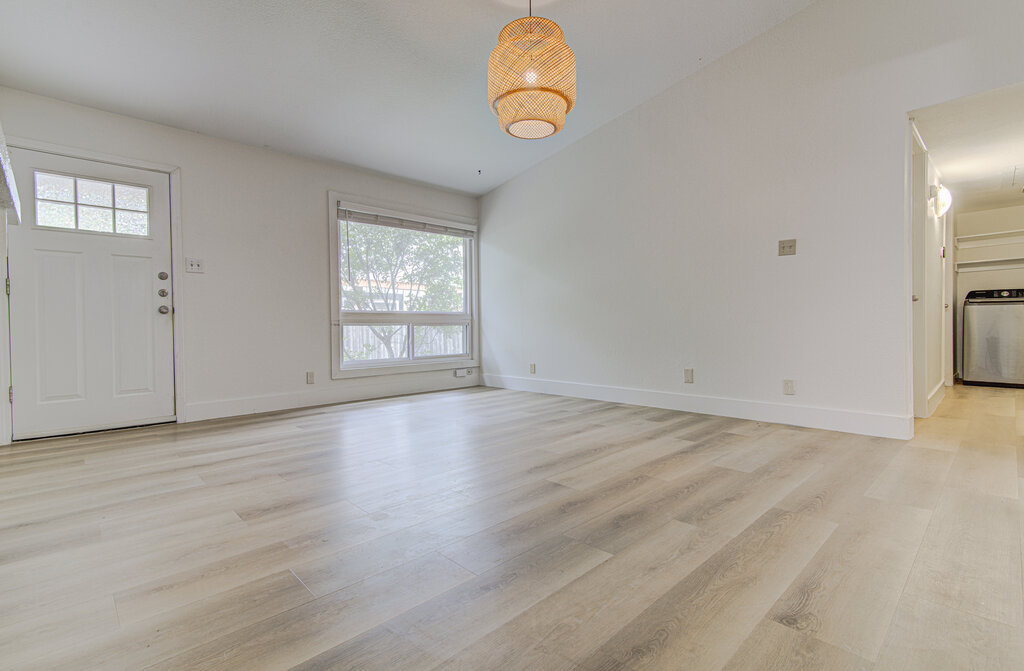 6713 West Gate Boulevard, Unit A Austin, TX 78745 - Photo 5 of 21 an empty room with wooden floor and windows
