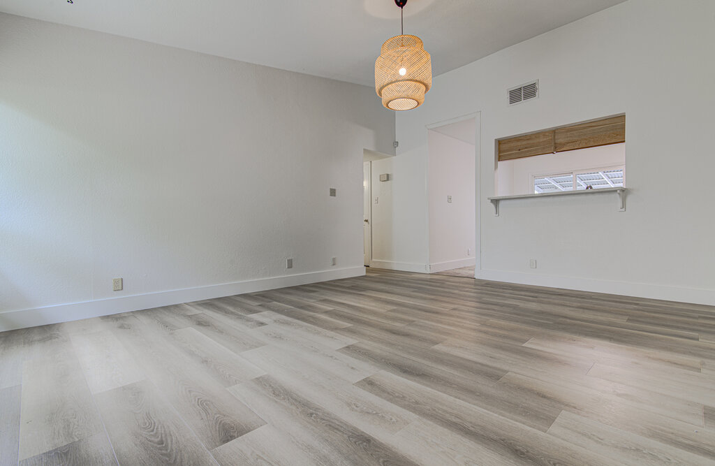 6713 West Gate Boulevard, Unit A Austin, TX 78745 - Photo 6 of 21 an empty room with wooden floor and windows