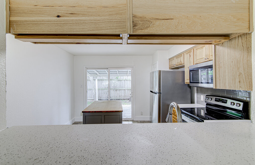 6713 West Gate Boulevard, Unit A Austin, TX 78745 - Photo 10 of 21 a kitchen with stainless steel appliances a refrigerator and a stove