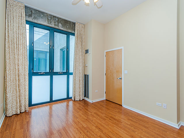 321 South Sangamon Street, Unit 901 Chicago, IL 60607 - Photo 11 of 18 a view of empty room with wooden floor and fan