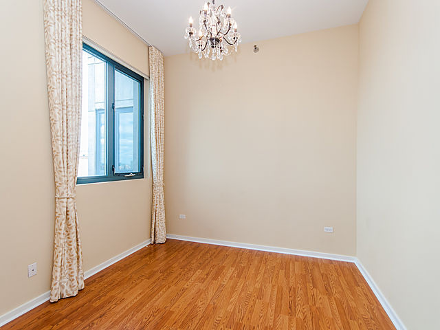 321 South Sangamon Street, Unit 901 Chicago, IL 60607 - Photo 14 of 18 an empty room with wooden floor and windows