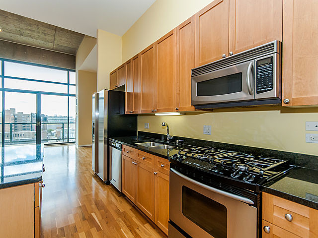 321 South Sangamon Street, Unit 901 Chicago, IL 60607 - Photo 4 of 18 a kitchen with a stove and a microwave