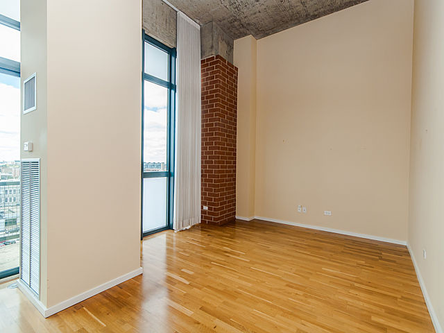 321 South Sangamon Street, Unit 901 Chicago, IL 60607 - Photo 9 of 18 a view of an empty room with wooden floor and a window