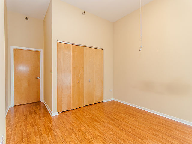 321 South Sangamon Street, Unit 901 Chicago, IL 60607 - Photo 10 of 18 a view of an empty room with wooden floor