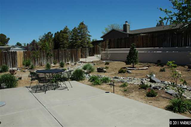 67 Zircon Drive Reno, NV 89521 - Photo 1 of 1 a view of backyard with a table and chairs a barbeque