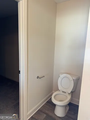 a white toilet sitting in a bathroom