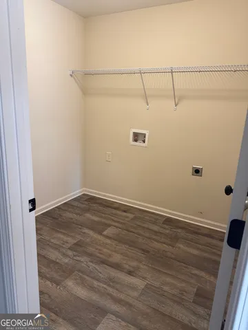 a view of a room with wooden floor