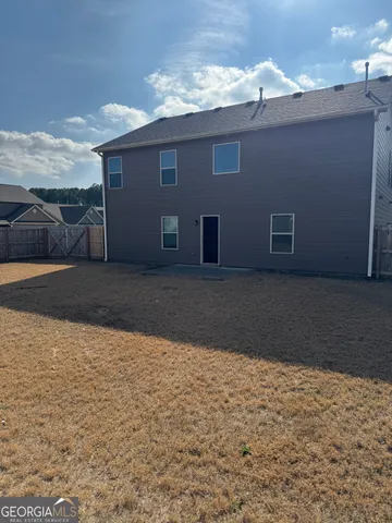 a backyard of a house with large trees