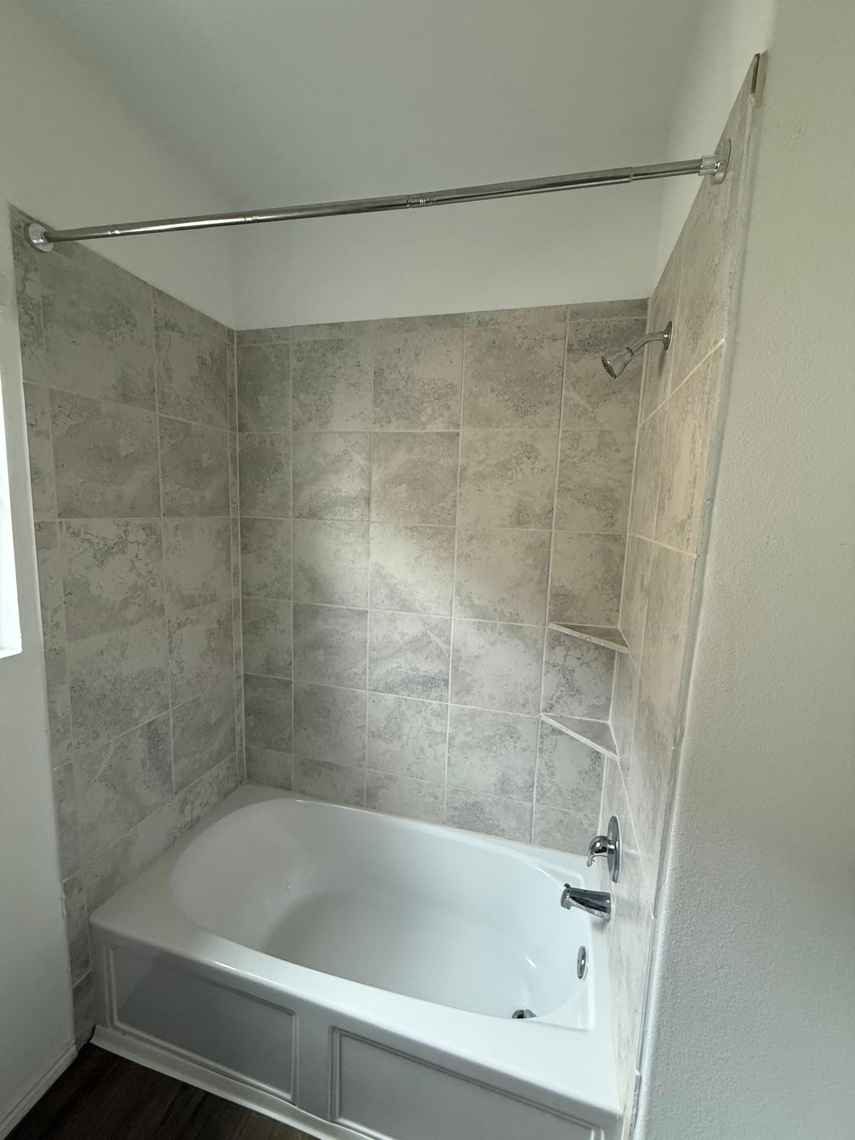 1521 Brueggerhoff Road Leander, TX 78641 - Photo 7 of 15 A tiled shower and tub combination anchors this clean bathroom space.