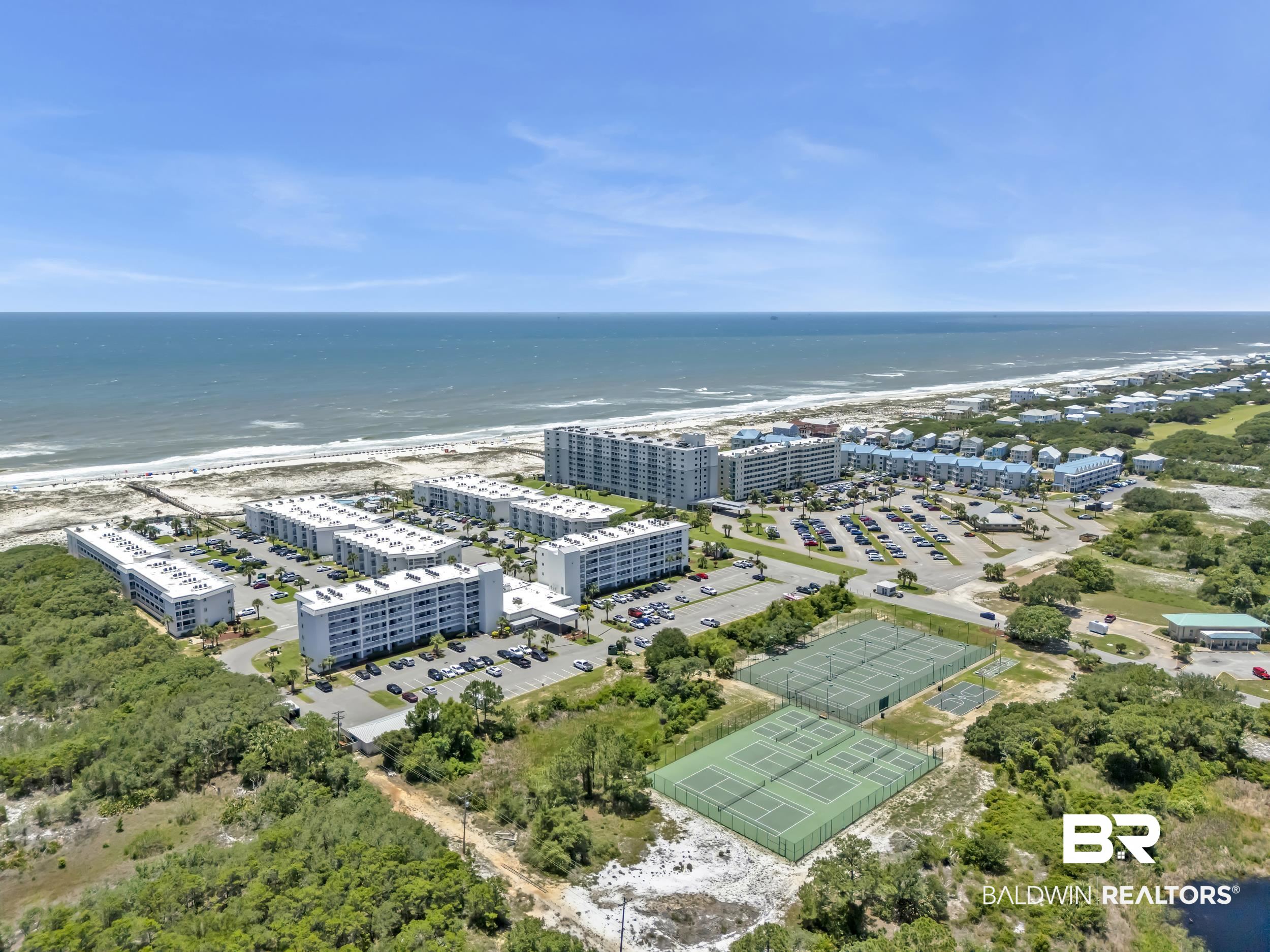 400 Plantation Road, Unit 2118 Gulf Shores, AL 36542 - Photo 55 of 59 Coastal community featuring multiple residential buildings, direct beach access, extensive paved parking, and multiple tennis courts