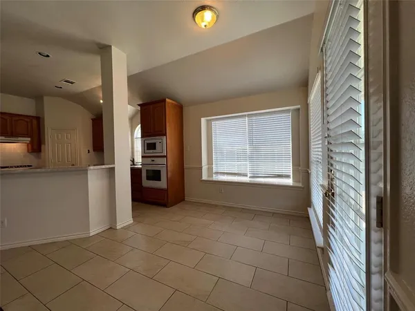 a view of a kitchen with a sink and a refrigerator