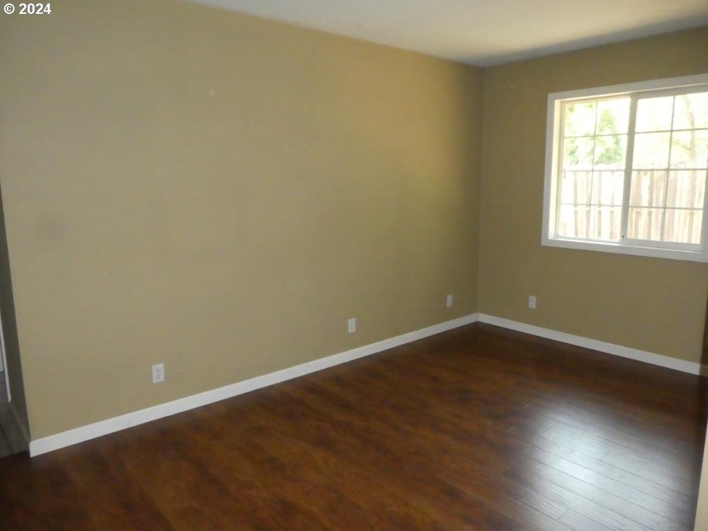 310 Southeast Terrace Drive Roseburg, OR 97470 - Photo 11 of 44 an empty room with wooden floor and windows