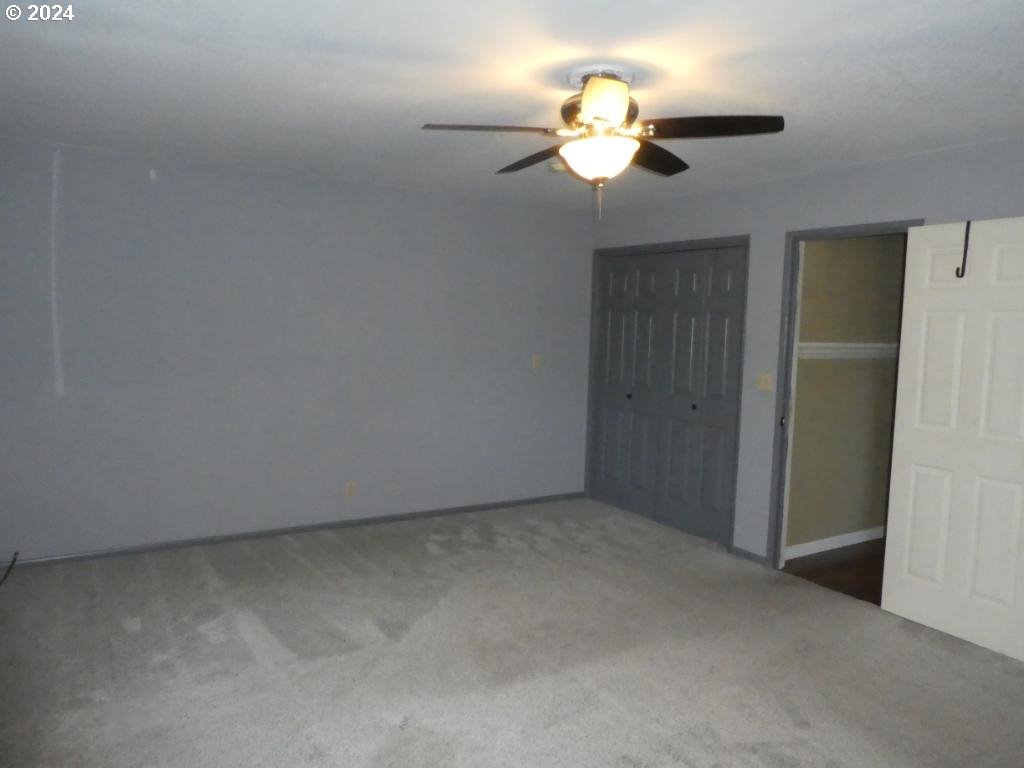 310 Southeast Terrace Drive Roseburg, OR 97470 - Photo 27 of 44 an empty room with a chandelier fan