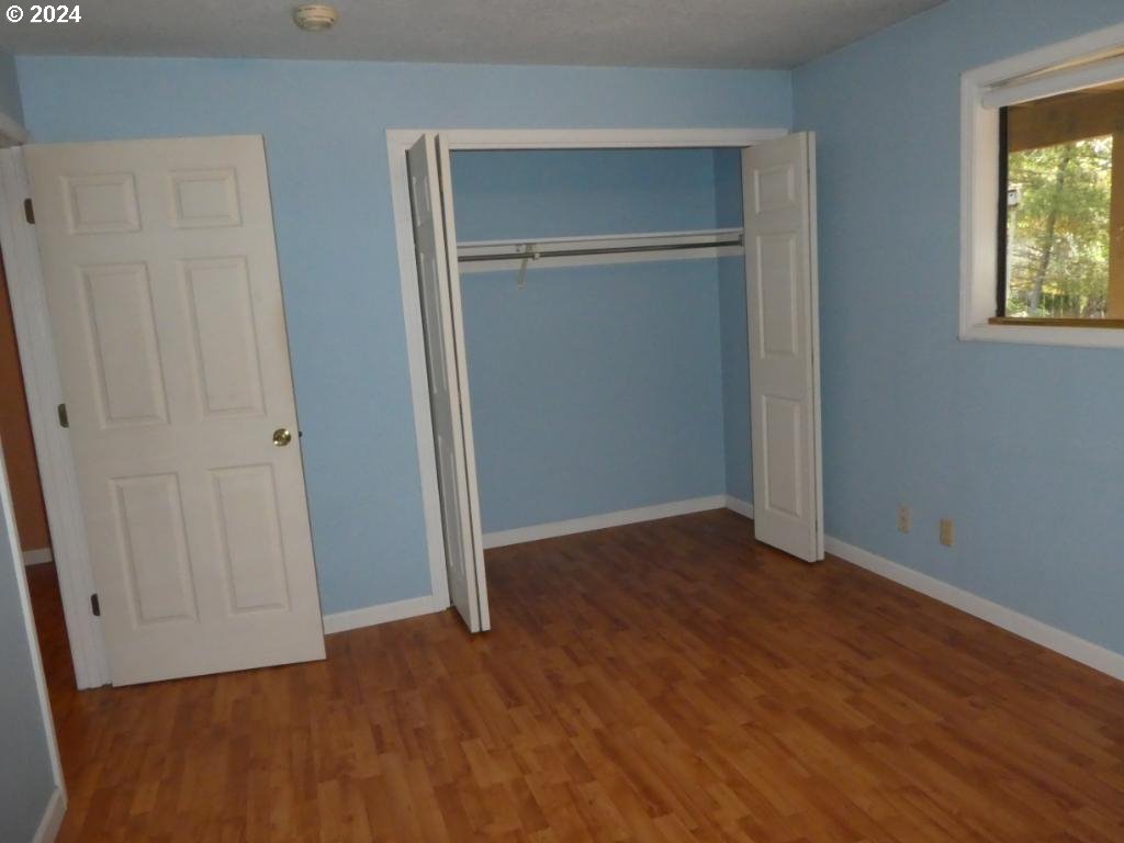 310 Southeast Terrace Drive Roseburg, OR 97470 - Photo 36 of 44 an empty room with wooden floor and closet area