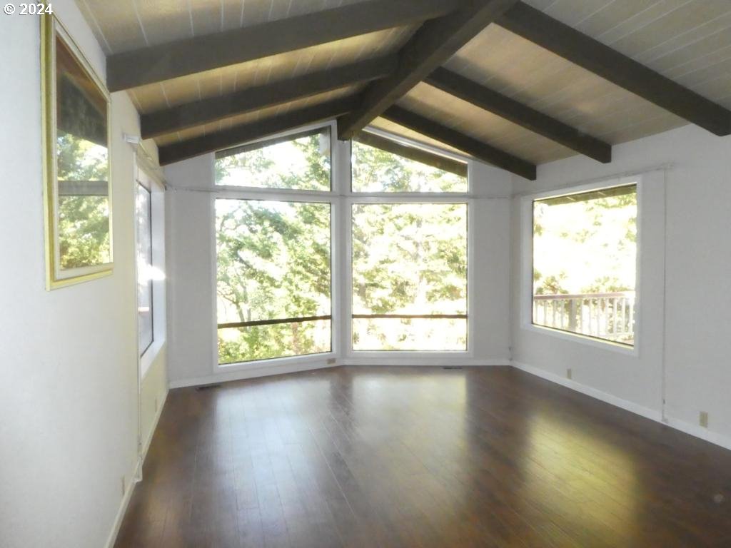 310 Southeast Terrace Drive Roseburg, OR 97470 - Photo 4 of 44 a view of an empty room with wooden floor and a window