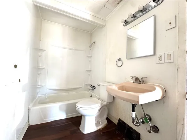 a bathroom with a sink a toilet and a mirror