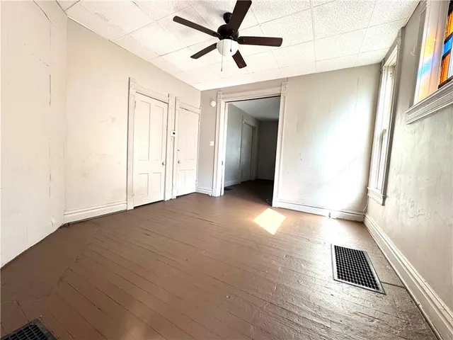 a view of a livingroom with wooden floor and a ceiling fan