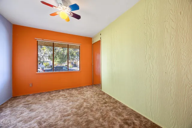 a view of a house with backyard and tree s