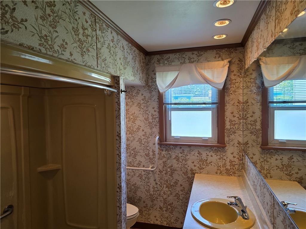 3134 Roxford Road Allentown, PA 18103 - Photo 29 of 34 A retro-inspired bathroom featuring floral wallpaper and a cheerful yellow sink with recessed lighting overhead.