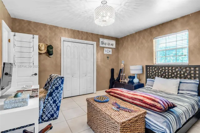 a bedroom with bed and window