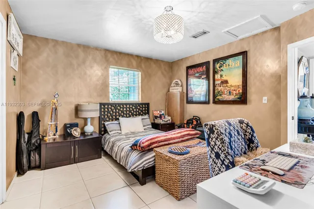 a bedroom with bed and window