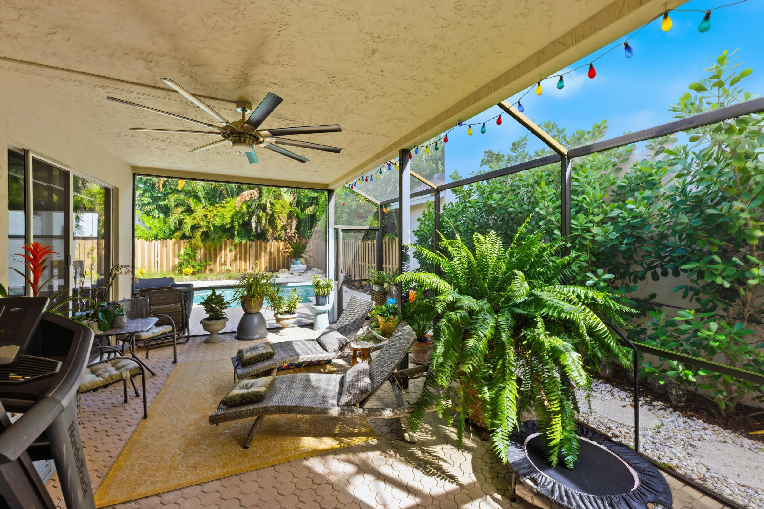 2495 Northwest 66th Drive Boca Raton, FL 33496 - Photo 33 of 74 a view of a patio with table and chairs potted plants with wooden floor