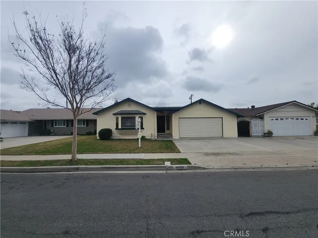 a house view with a bench in front of it