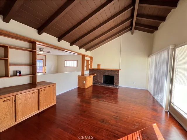 a kitchen with stainless steel appliances granite countertop a sink dishwasher and a stove with wooden floor
