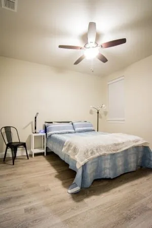 a bedroom with bed and window