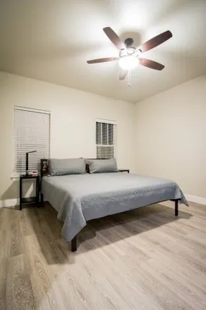 a bedroom with a bed and a chandelier