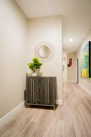 a view of a room with wooden floor