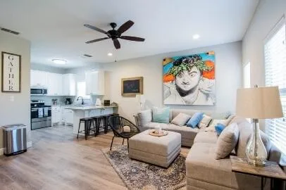 a living room with furniture and kitchen view