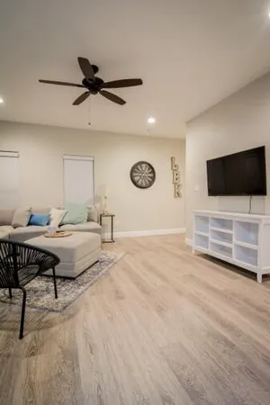 a bedroom with a bed and a ceiling fan